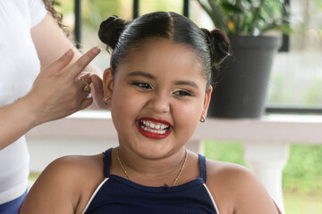 Latin girl happy to be made up and do her hair