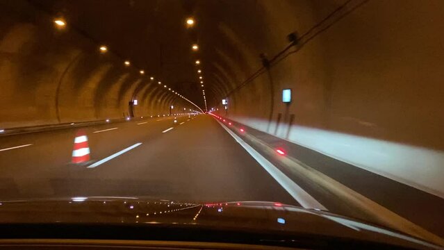 car drive in a tunnel with lights.
