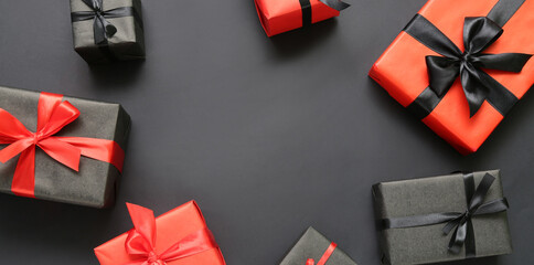 Frame made of gift boxes on dark background, top view