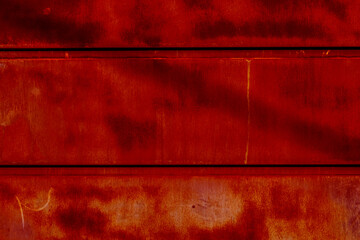 Aged copper plate texture with red patina stains. Old and worn metal background