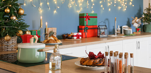 Modern interior of kitchen with Christmas decorations and gifts