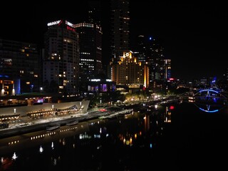 Fototapeta na wymiar aerial view of Melbourne city skyline at night High rise apartments and office space lit up in the dark displaying the City skyline
