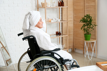 Mature woman with physical disability in bathroom