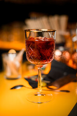 close-up view of crystal goblet with red alcoholic drink on bar counter