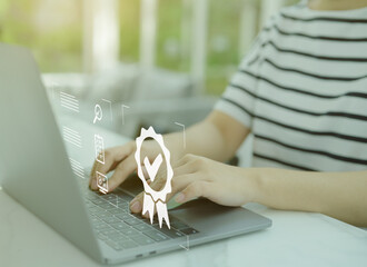 Businesswoman using laptop computer with a sign of the top service quality assurance and document...