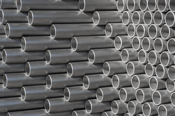 Silver aluminum pipe tubes stacked in a store or construction site.
