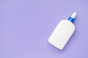 Bottle of glue on lilac background