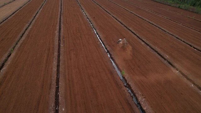 Peat Harvester Tractor on Collecting Extracting Peat. Mining and harvesting peatland. Area drained of the mire are used for peat extraction. Drainage and destruction of peat bogs. turf.