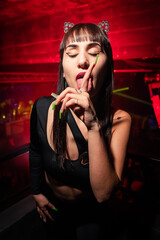 Buenos Aires, Argentina; 08-24-2022: a beatiful girls posing for a photo at a party. Young people dancing in night club party. selective focus. Long exposure. Moving lights. party concept. Party night