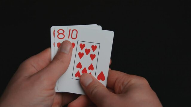 Close-up of playing cards poker combinations on black background 