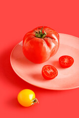 Plate with ripe tomatoes on color background, closeup