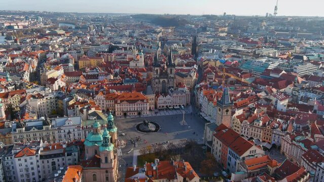 Old Town Square aerial drone shot in the historic center of Prague, the capital of the Czech Republic ft beautiful above view of Tyn and St. Nicholas Church around famous gothic landmarks on sunny day