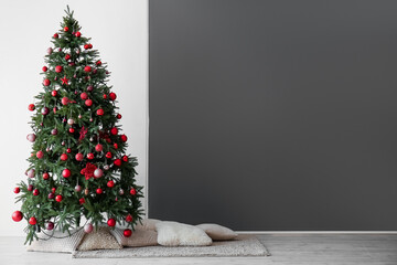 Christmas tree, carpet with pillows near black and white wall