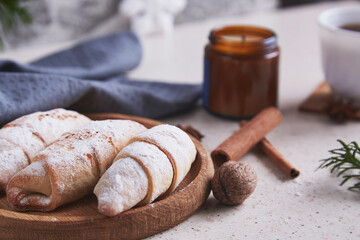 Classic aesthetic Christmas crescent handmade bagels with cinnamon sticks and walnuts. Cozy home