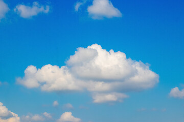 Naklejka na ściany i meble A big white fluffy cloud in the blue sky