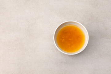Yuzu tea or Yuja cha on stone table, top view. Popular Korean tea. Honey citron beverage. Healthy drink