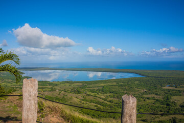 View of the coastline of the Atlantic Ocean on the island of Haiti. Green coastline turns into ocean