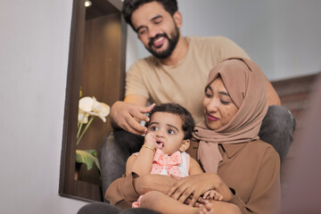 Happy Indian Muslim Family with little Daughter at Home
