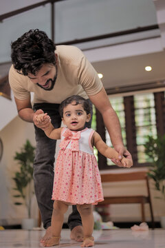 Happy Indian Muslim Family with little Daughter at Home