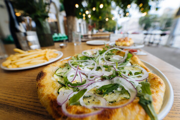 Vegetarian pizza in street fast food outdoor cafe.