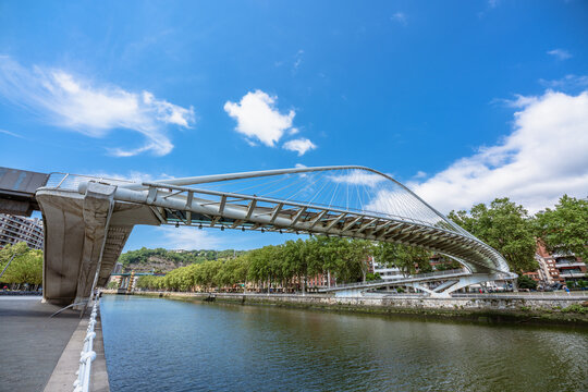 Bilbao, Spain. 08/07/2022. Zubizuri White Bridge is a bridge over Nervi&oacute;n river R&iacute;a de Bilbao designed by Santiago Calatrava and was opened in 1997