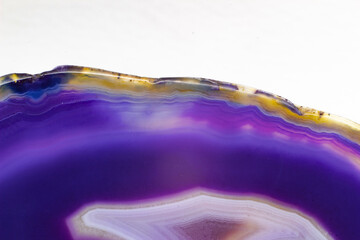 Purple and Blue agate slice crystal , banded chalcedony stone isolated on a white background...