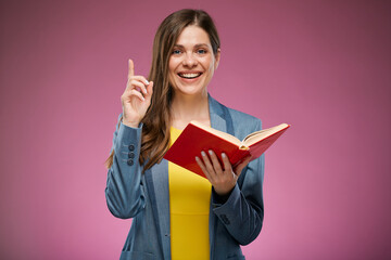 Smiling school teacher holding book and pointing finger up. Isolated advertising portrait.