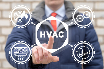 Businessman using virtual touchscreen presses abbreviation: HVAC. HVAC - Heating Ventilation Air...