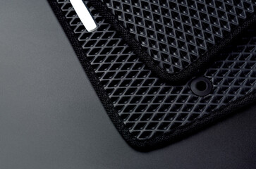 New black car mats made from eva ethylene vinyl acetate. Close up view.