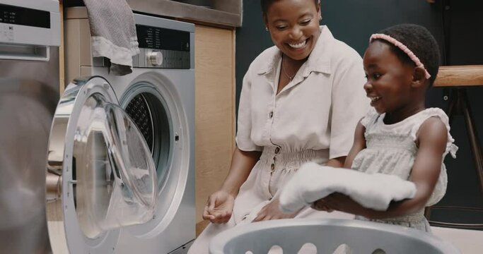 Mother, child and laundry with high five for teamwork, help and support working together for chores at home. Happy African American mom and helpful kid folding clothes in basket celebrating success