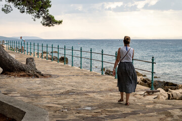 Pedestrian path passing parallel with sea shore of Brac island at the town of Supetar, Croatia,...