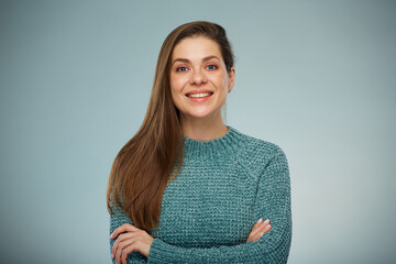 Confident woman in green sweater standing with arms crossed. Advertising female studio portrait.