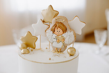 Front view of birthday cake for newborn baby. Beautiful cake, covered with glaze and decorated with...