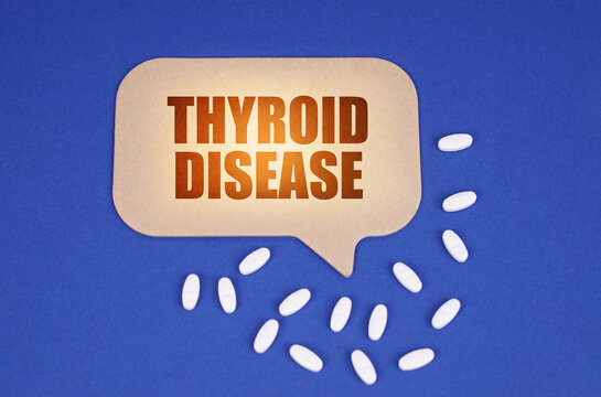 On the blue surface of the tablet and a cardboard plate with the inscription - Thyroid disease