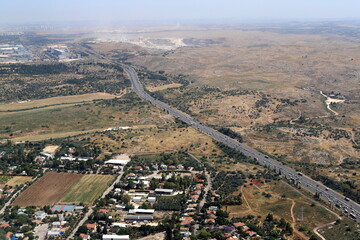 The earth is seen through the porthole of a large jet plane.