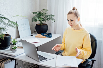 Online Side Hustle Ideas To Make Money Fast. Young woman speaking in front of laptop as consultant,...