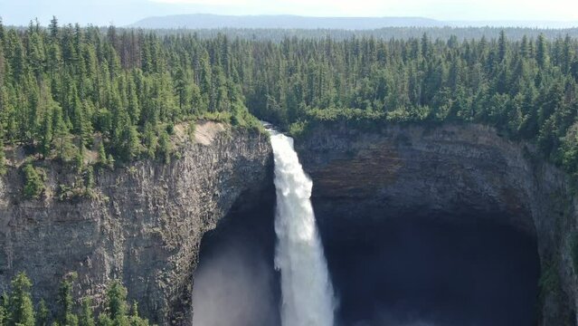 Aerial shot of the scenic Helmcken Falls in Canda with dense vegetation covering the cliff