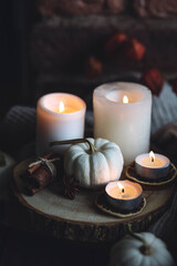 Autumn home composition with aromatic candle, dry citrus, cinnamon, anise. Aromatherapy on a grey fall morning, atmosphere of cosiness and relax. Wooden background close up copy space