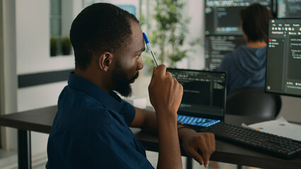 African american system engineer thinking about html script development to code it language in...