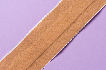 Long strip of brown medical plaster band aid.