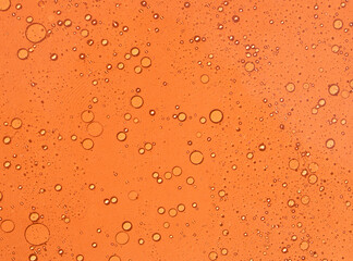 Fondo abstracto y acuoso con burbujas de color naranja. Recurso para cartelería y diseño	