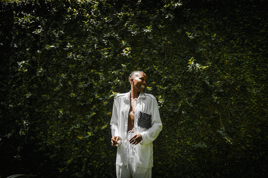 a black woman laughing in a garden