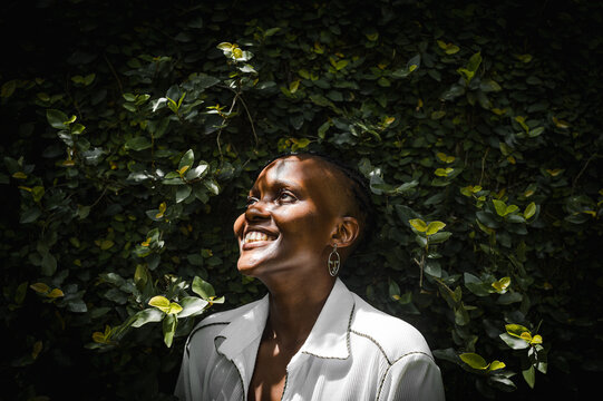 Closeup of black woman smiling in garden 