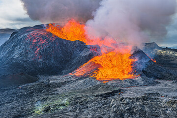 Heavy smoke over an active volcanic crater. Lava flow from an active volcano in Iceland. Landscape...