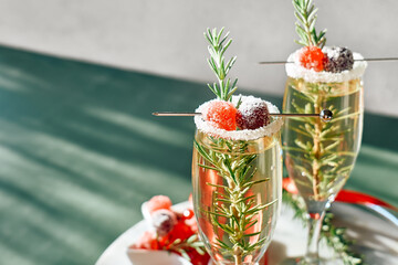 Christmas cocktail with sparkling wine, rosmary and cherry. Winter xmas and new year  holidays...