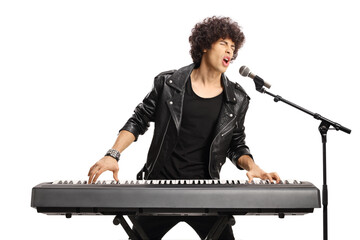Young man with curly hair playing a digital piano and singing