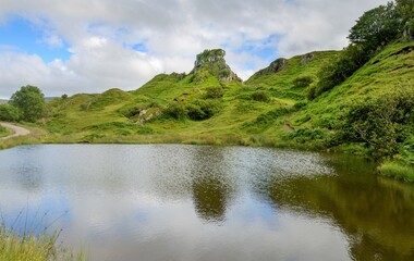 Fototapeta na wymiar Castle Ewan above pond,Fairy Glen,summertime,Trotternish,Isle of Skye,Highlands of Scotland.