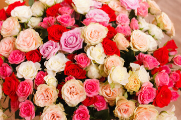 Obraz na płótnie Canvas A bouquet of roses. A big bouquet of flowers. Multicolored roses. Delicate wedding bouquet.
