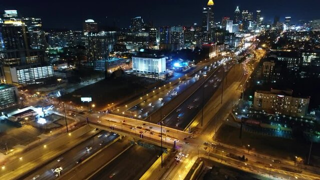 Aerial Panning Shot Of Modern Building Of Restaurant In Illuminated City At Night - Atlanta, Georgia
