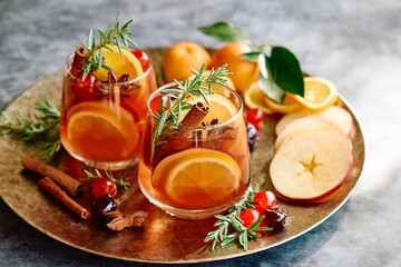 Obraz na płótnie Canvas Mulled wine or christmas sangria with aromatic spices, apple, cherry and citrus fruits. Traditional Christmas festive warming spiced drink with orange, berry, cinnamon, cardamom and anise.